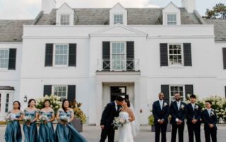 The bride and the groom share a heartfelt moment of love with the bridesmaids and the groomsmen in front of the mesmerizing Harding Waterfront Estate
