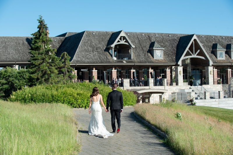 The young couple standing on Eagle Nest Golf hills for their photoshoot.
