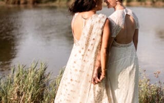 The couple is seen admiring the beautiful lakes present at this location.